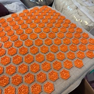 Pranamat Eco massage set with pillow, orange on natural.